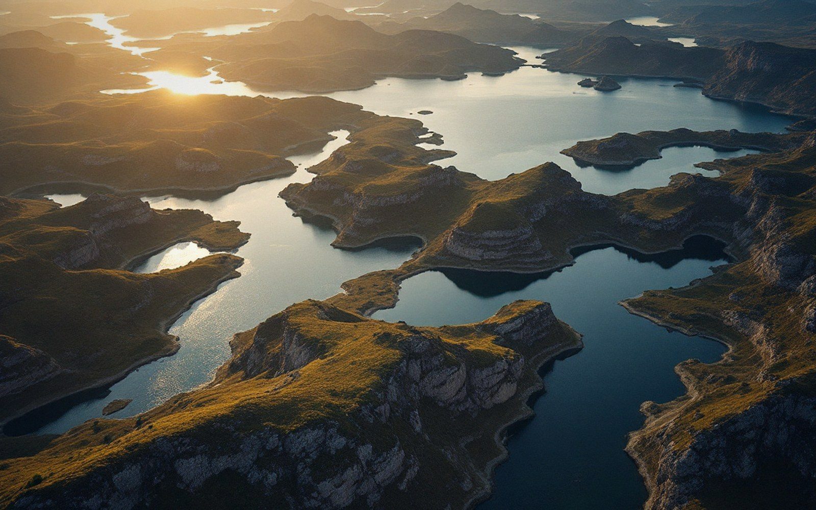 A low aerial over a maze of interconnected lakes and rock ridges